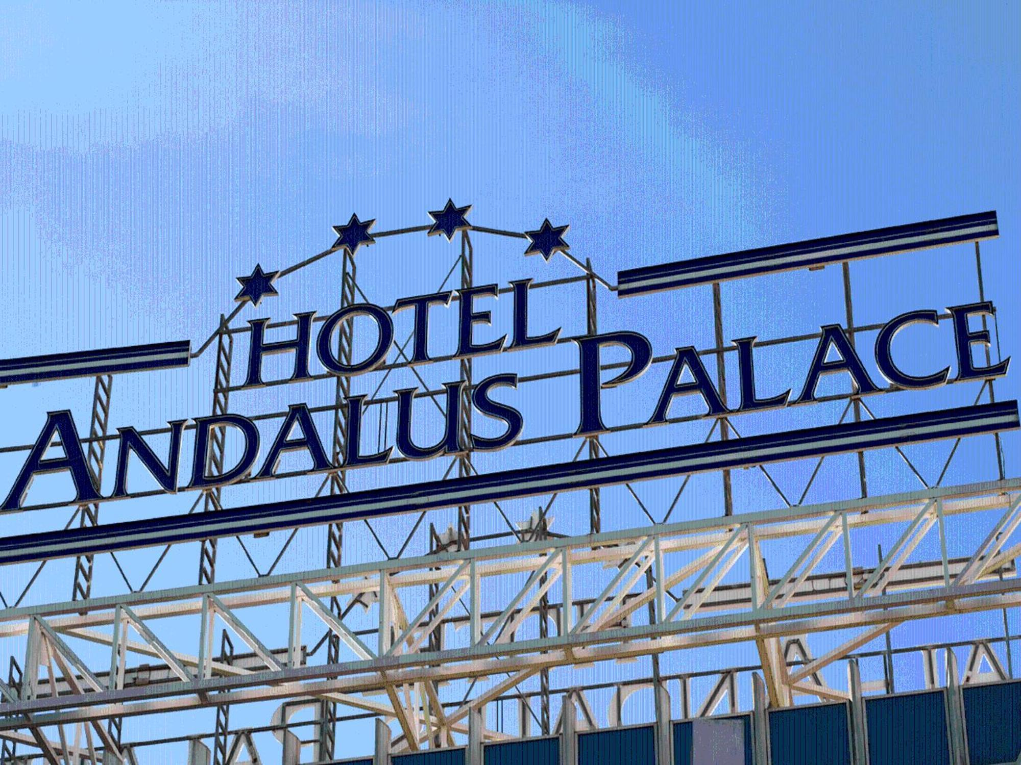 Silken Al-Andalus Palace Sevilla Exterior foto The photo shows the sign for "Hotel Andalus Palace." The sign is prominently displayed with a blue background and white lettering. Above the name, there are three decorative stars. The overall look is modern and inviting, set against a clear blue sky